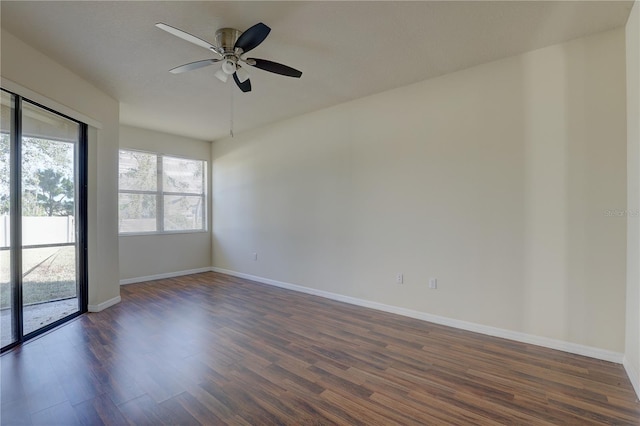 spare room with ceiling fan and dark wood-type flooring