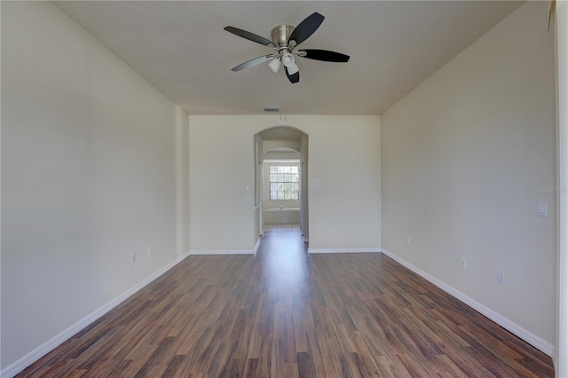 spare room with ceiling fan and dark hardwood / wood-style floors