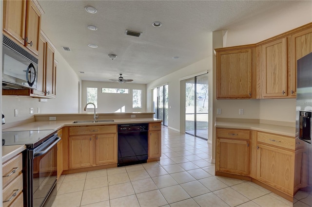 kitchen featuring black appliances, ceiling fan, light tile patterned floors, and sink