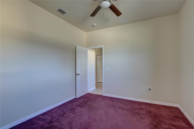 carpeted spare room featuring ceiling fan