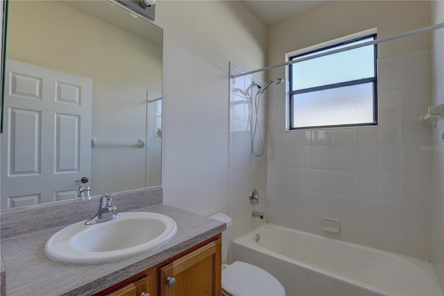 full bathroom with vanity, tiled shower / bath combo, and toilet