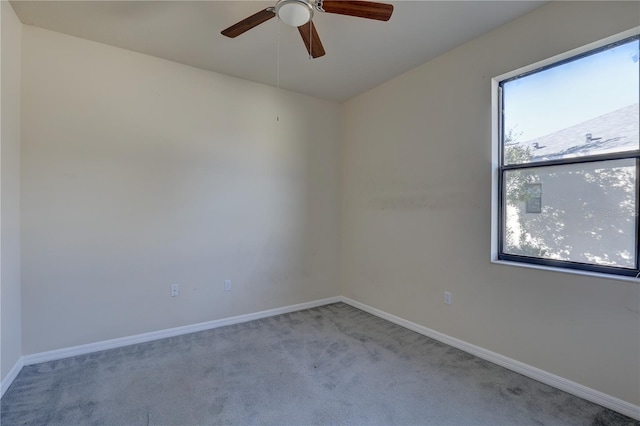 unfurnished room with ceiling fan and light colored carpet