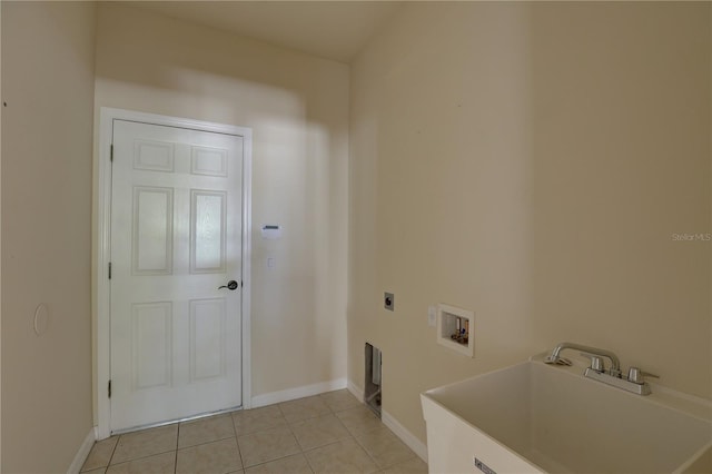 laundry area featuring electric dryer hookup, light tile patterned flooring, sink, and hookup for a washing machine