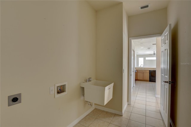 laundry area featuring hookup for an electric dryer, light tile patterned flooring, sink, and hookup for a washing machine