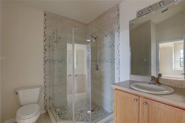 bathroom featuring tile patterned flooring, lofted ceiling, toilet, a shower with door, and vanity