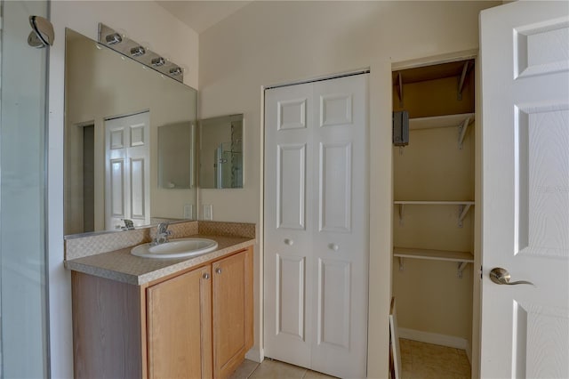 bathroom featuring tile patterned flooring and vanity