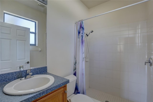 bathroom with walk in shower, vanity, and toilet