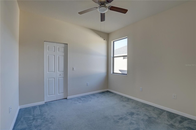 spare room featuring carpet flooring and ceiling fan