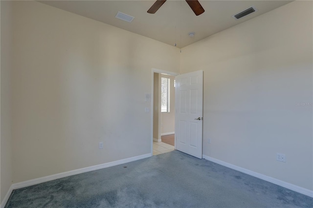 empty room with ceiling fan and light colored carpet