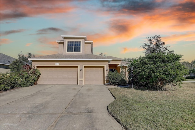 view of front facade featuring a lawn and a garage