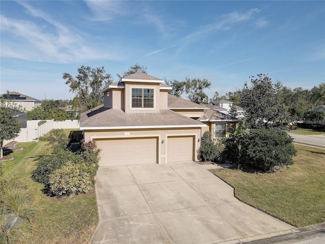 view of front of house featuring a garage and a front lawn