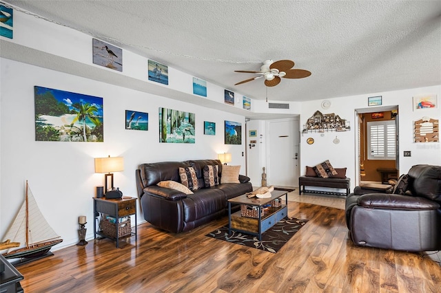 living room with ceiling fan, hardwood / wood-style floors, and a textured ceiling