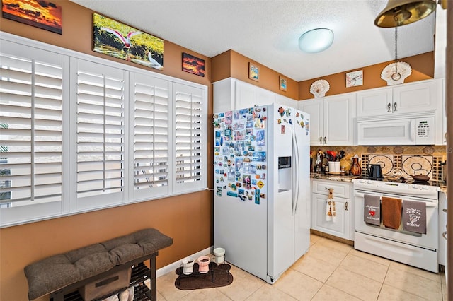 kitchen with tasteful backsplash, white appliances, a textured ceiling, light tile patterned floors, and white cabinetry