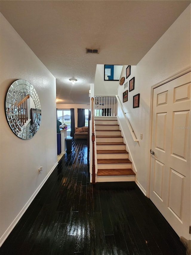 interior space featuring hardwood / wood-style flooring and a textured ceiling