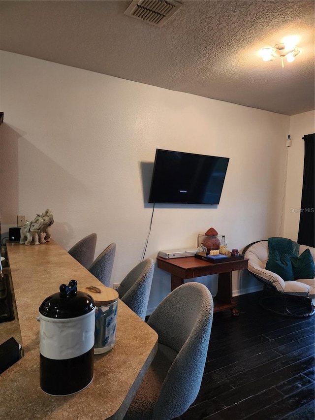 home office featuring dark hardwood / wood-style flooring and a textured ceiling