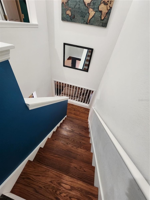 stairs featuring hardwood / wood-style floors