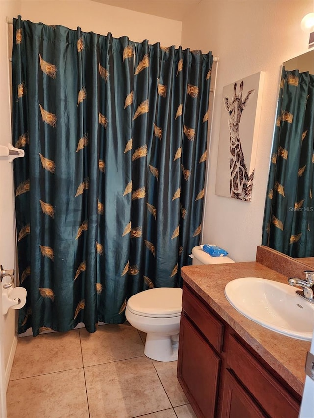 bathroom featuring tile patterned floors, vanity, and toilet