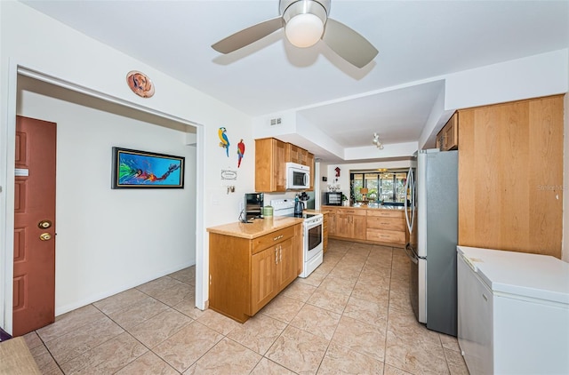 kitchen featuring ceiling fan, white appliances, and light tile patterned floors