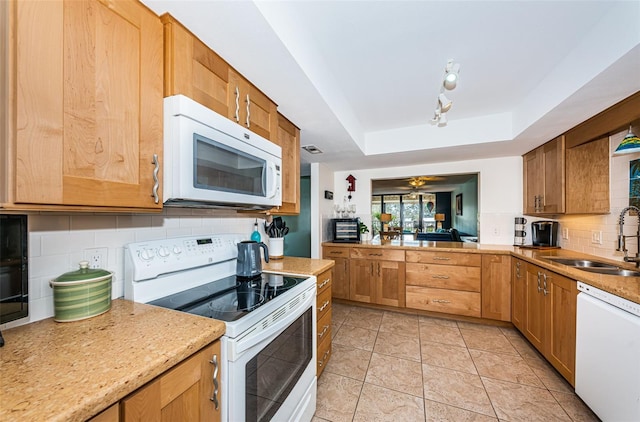 kitchen featuring white appliances, a raised ceiling, ceiling fan, sink, and light tile patterned floors