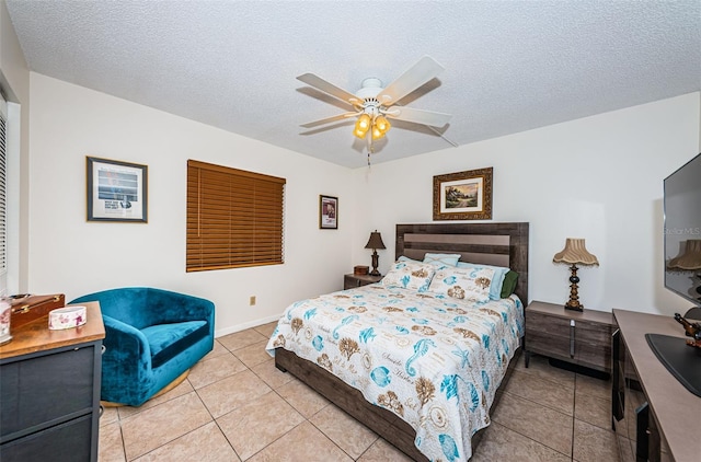 tiled bedroom with ceiling fan and a textured ceiling