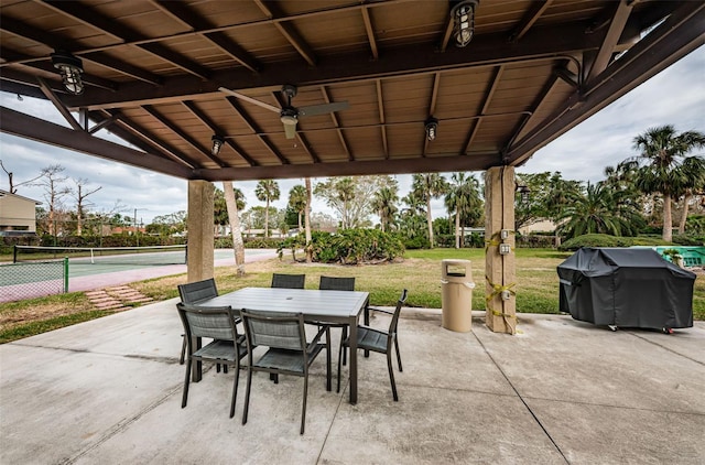 view of patio featuring tennis court and ceiling fan