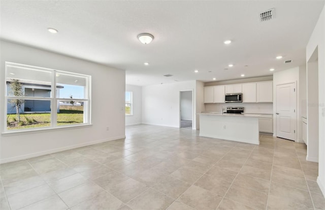 unfurnished living room featuring light tile patterned flooring