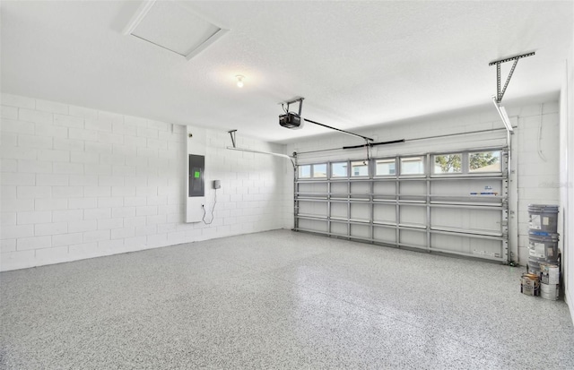 garage with a garage door opener and electric panel