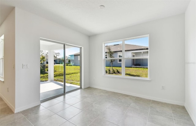 unfurnished room featuring light tile patterned floors