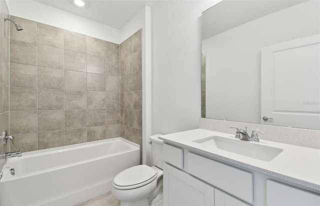 full bathroom featuring vanity, tiled shower / bath combo, and toilet