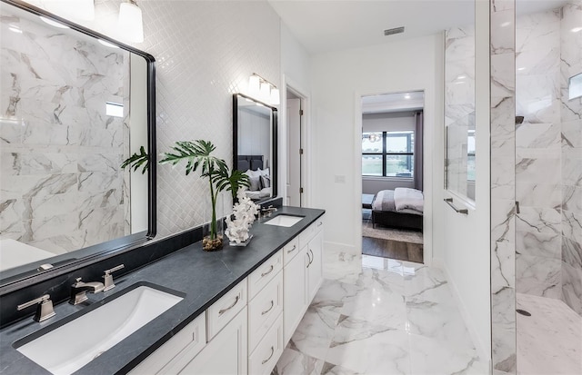 bathroom with vanity and tiled shower