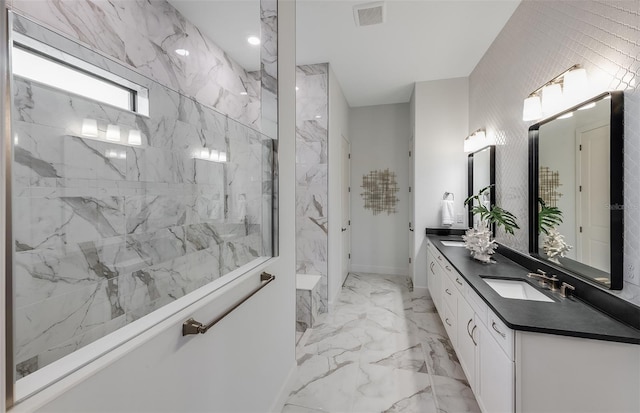 bathroom with vanity and tiled shower