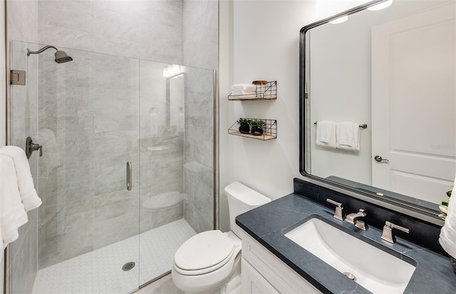 bathroom featuring vanity, toilet, and an enclosed shower