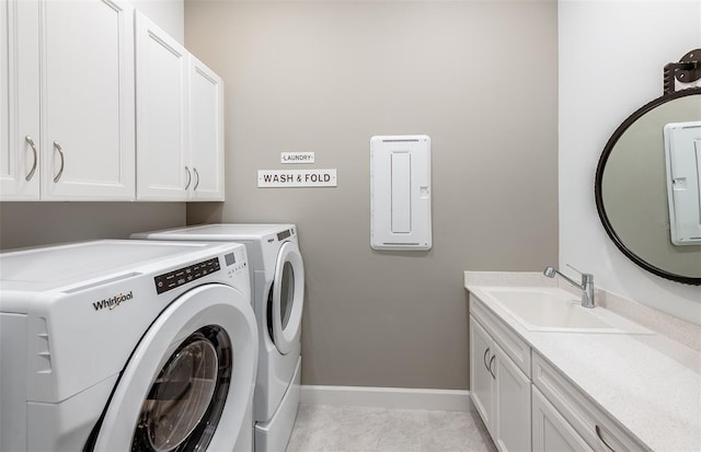 laundry room with washer and dryer, cabinets, light tile patterned floors, and sink