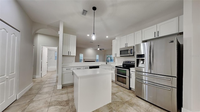 kitchen featuring white cabinetry, sink, pendant lighting, and appliances with stainless steel finishes