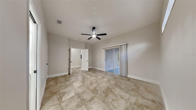 interior space featuring access to exterior, multiple windows, and ceiling fan