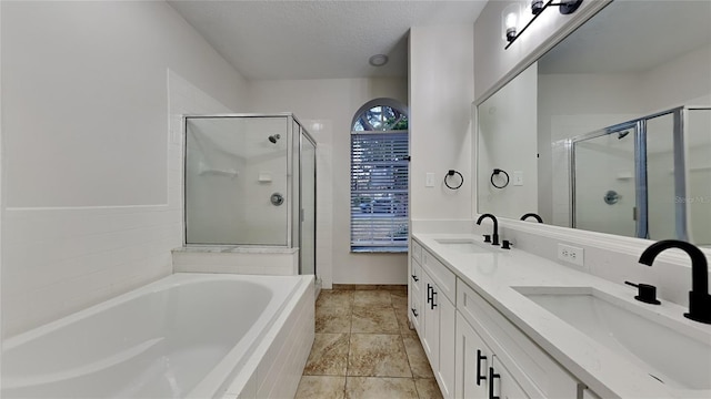 bathroom with vanity, separate shower and tub, and a textured ceiling