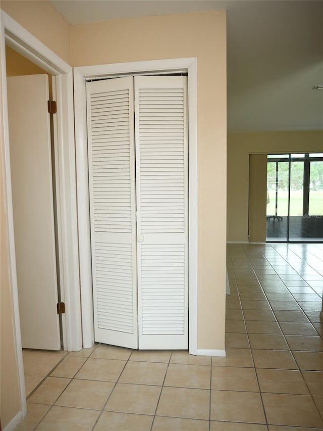 hall featuring light tile patterned flooring