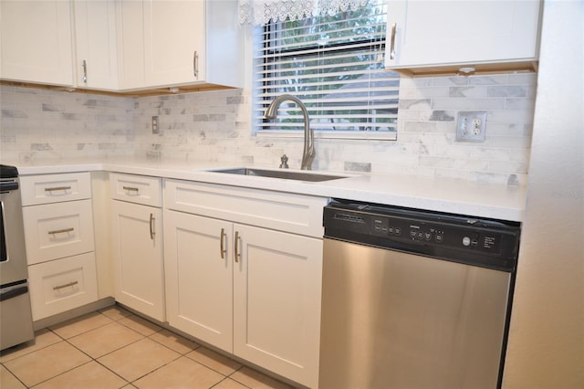 kitchen featuring stainless steel dishwasher, light tile patterned flooring, sink, and white cabinets