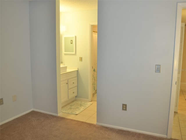 bathroom featuring tile patterned flooring and vanity