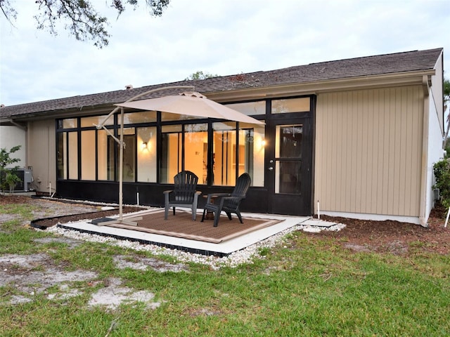 rear view of property with a patio and a yard