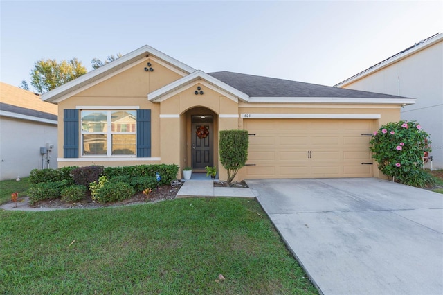 single story home with a garage and a front lawn