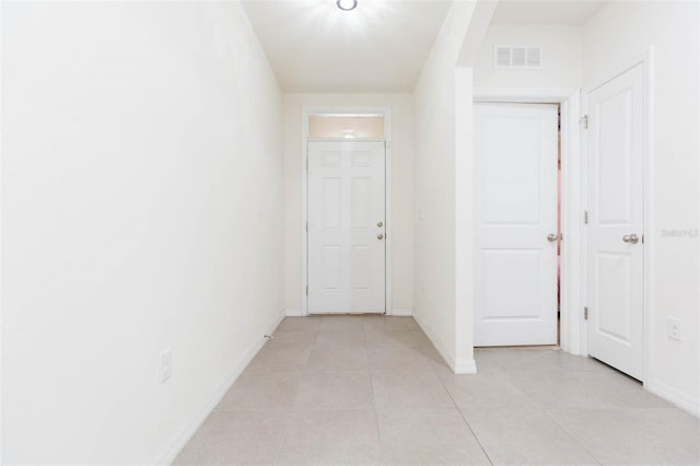 hallway featuring light tile patterned flooring