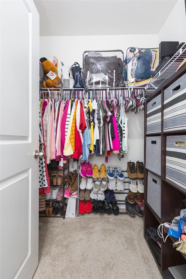 walk in closet featuring carpet