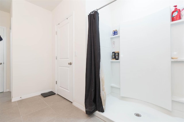 bathroom with tile patterned floors and curtained shower