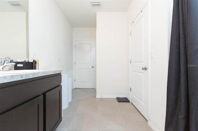 bathroom with tile patterned floors and vanity