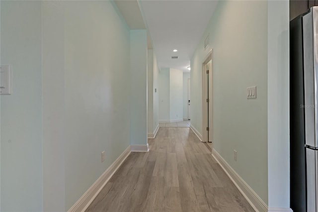 corridor with light hardwood / wood-style flooring