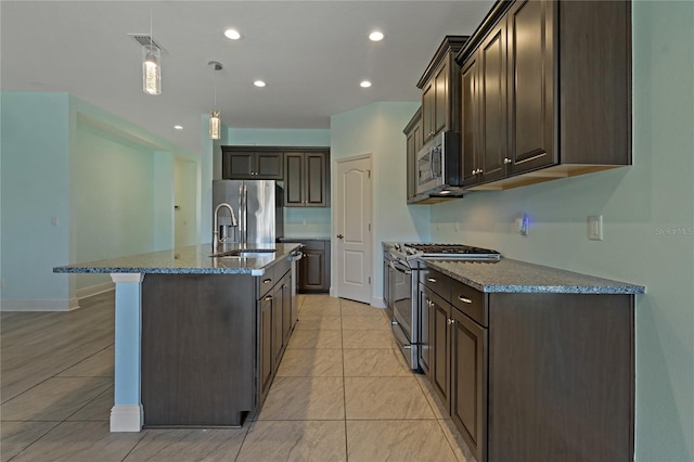 13584 Old Creek Ct, Parrish, FL 34219 - kitchen featuring appliances with stainless steel finishes, a sink, dark brown cabinets, dark stone counters, and pendant lighting