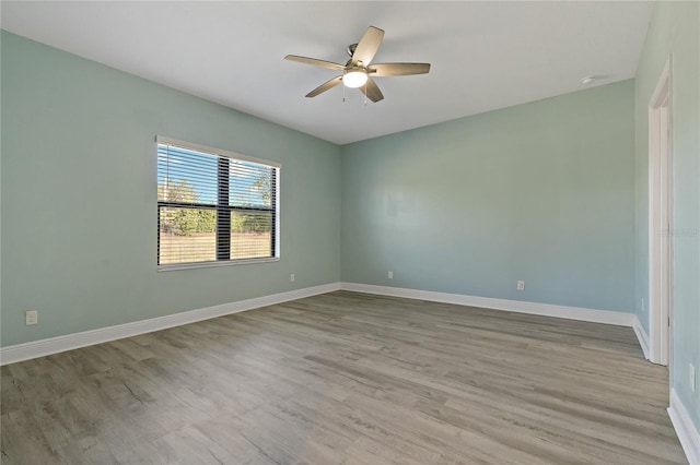 13584 Old Creek Ct, Parrish, FL 34219 - empty room featuring a ceiling fan, wood finished floors, and baseboards