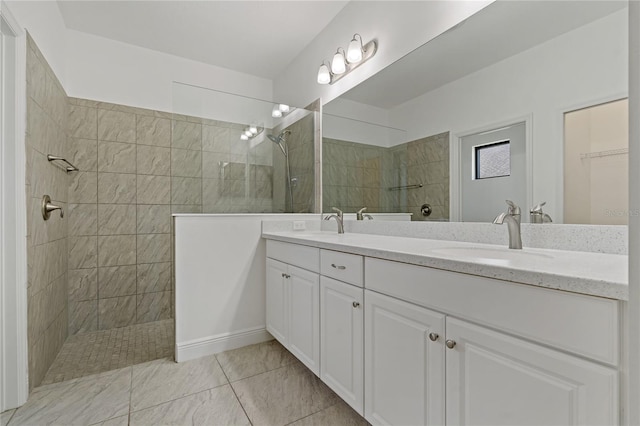 bathroom featuring a tile shower and vanity