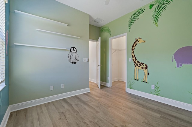 empty room with light hardwood / wood-style floors and a wealth of natural light